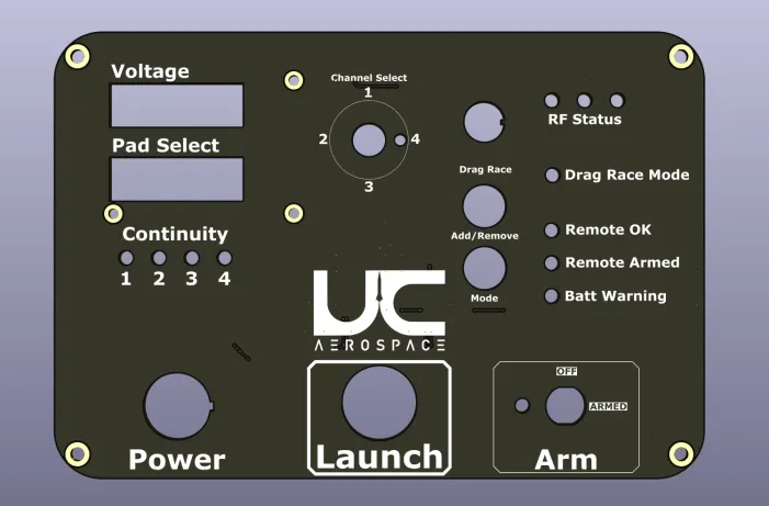 The final panel design. A dark faceplate carries two rectangular display cut-outs labelled Voltage and Pad Select, four continuity indicators numbered one to four, a four-position channel selector, and buttons for Drag Race, Add/Remove and Mode. Status indicators down the right side read RF Status, Drag Race Mode, Remote OK, Remote Armed and Batt Warning. Power and Launch buttons run along the bottom beside a keyed Arm switch marked OFF and ARMED, with the UC Aerospace logo set into the centre of the panel.